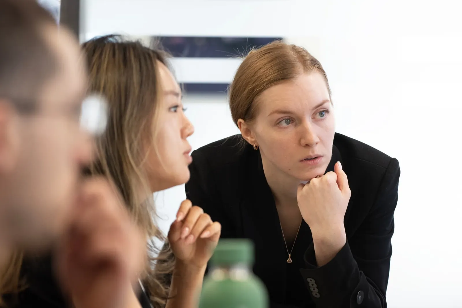 Two Motiv colleagues listening intently during a working session